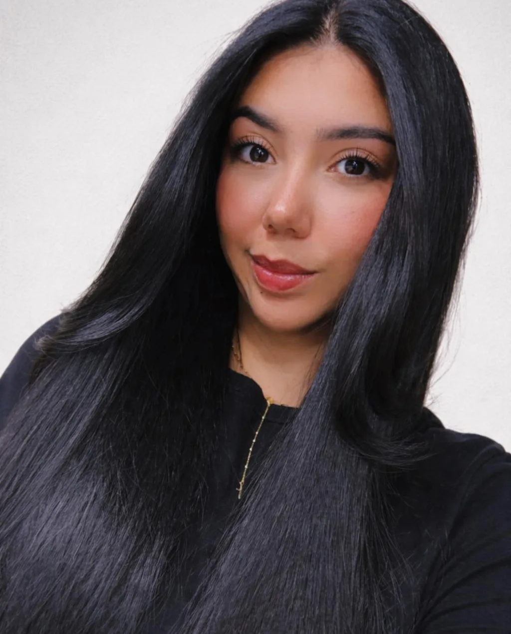 Juliana Henson — portrait with long dark hair against a warm ivory background